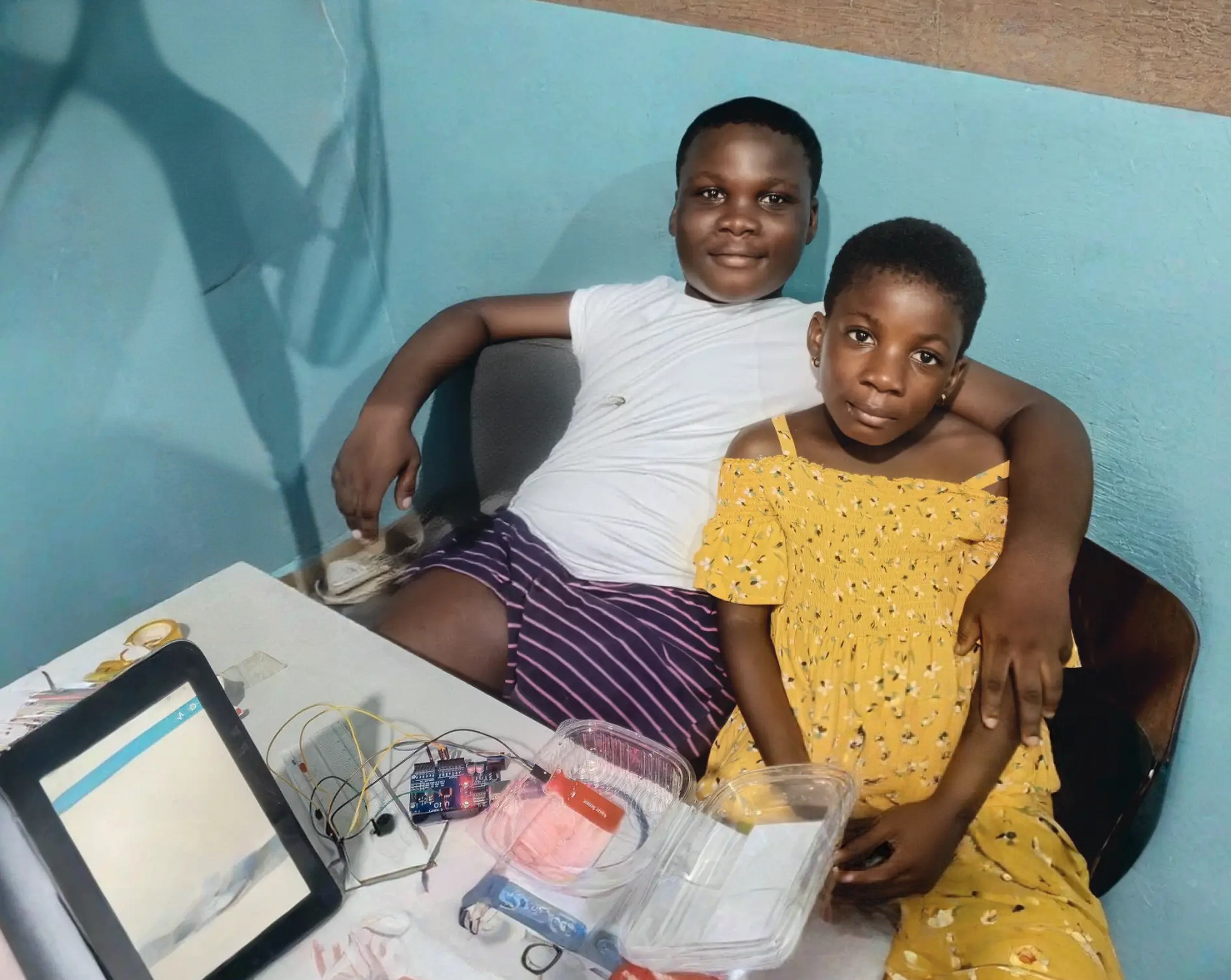 A student and tutor building a robot at home